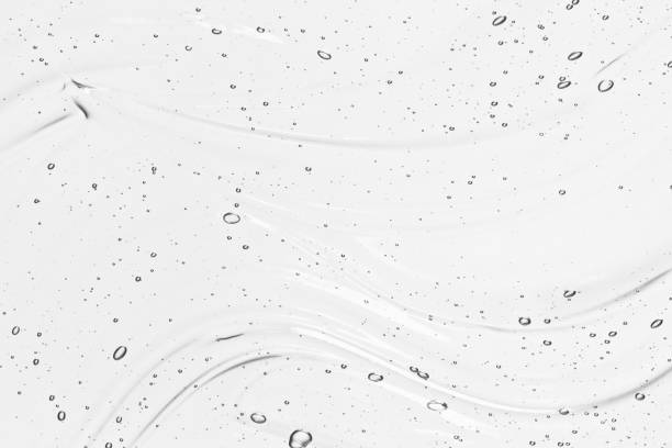 Hyaluronic acid serum texture. Clear gel background Hyaluronic acid serum texture. Beauty skin care liquid gel background. Clear cosmetic cream with bubbles close-up face serum photos stock pictures, royalty-free photos & images