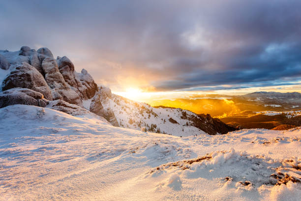Winter mountain Sunset. Landscape with dramatic clouds and snow