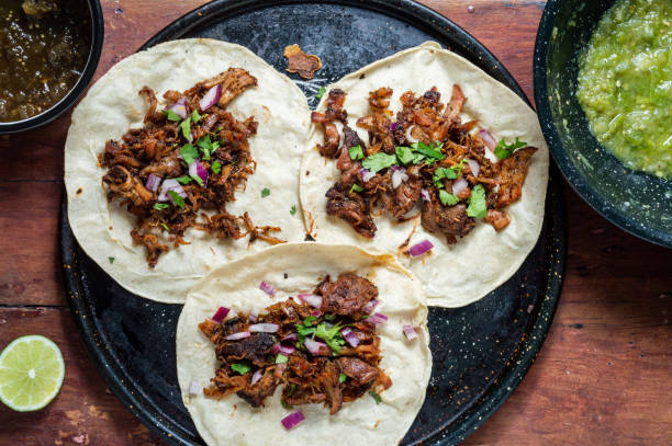 istock Carnitas tacos with red onion and raw green salsa 1221303736