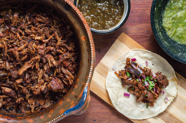 Carnitas tacos with red onion and raw green salsa