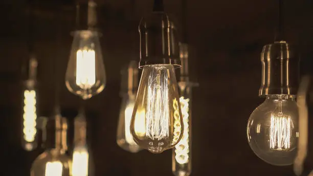 Vintage style light bulbs hanging from the ceiling. Old Edison light bulb.