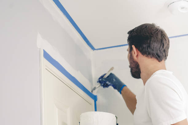 close up of painter hands with gloves painting the wall edge by door frame. - brushing human hand paintbrush artist imagens e fotografias de stock