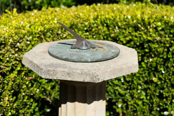 istock Garden sun dial with hedge in the background 1221306345