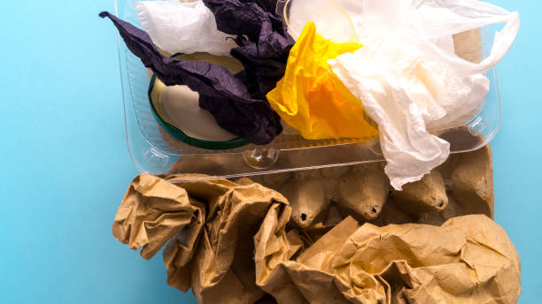 istock Garbage from plastic, paper, cardboard, cellophane and iron on a blue background. 1221307454