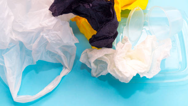 istock Garbage collection, ecology, seasonal cleaning. Garbage from plastic, paper, iron, cellophane on a blue background. 1221308405
