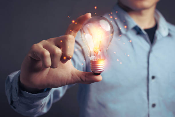 istock Man holding light bulbs, ideas of new ideas beautiful creative. 1221309271