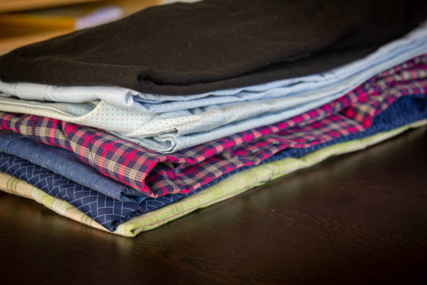 istock View of the folded shirts stacked over one another after ironed. 1221309398