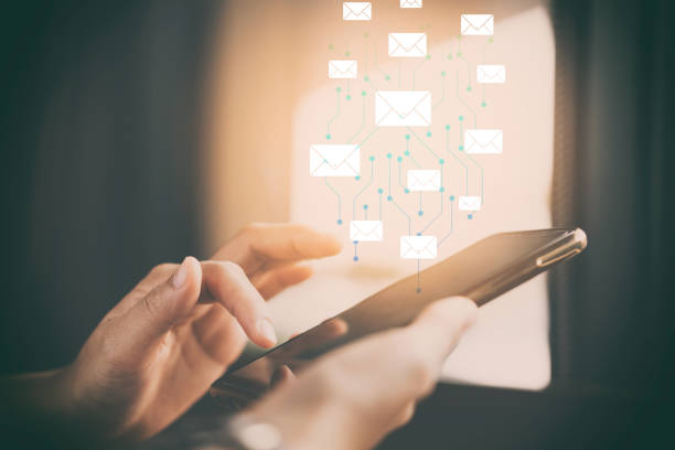 istock Woman hand using smart phone at coffee shop with email icon flying abstract background. 1221310138