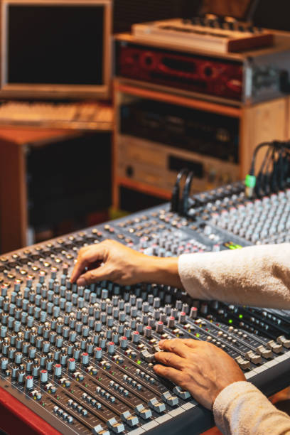 istock sound engineer hands working on audio mixing console in recording, broadcasting studio 1221310585