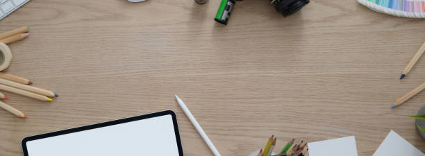istock Overhead shot of artist workspace with blank screen tablet, painting tools, notepad and copy space 1221310666