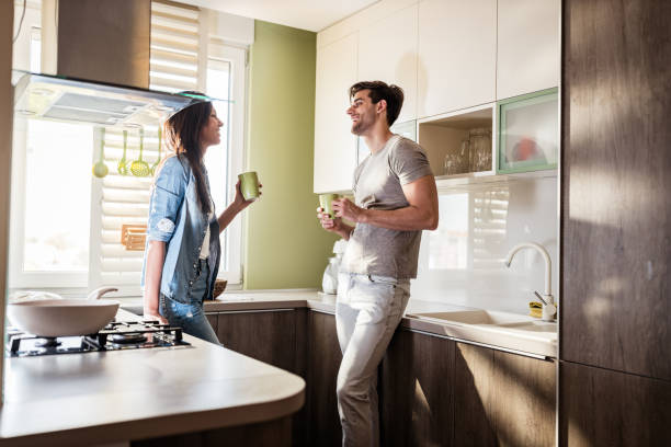 istock Happy couple talking during coffee time in the kitchen. 1221311689