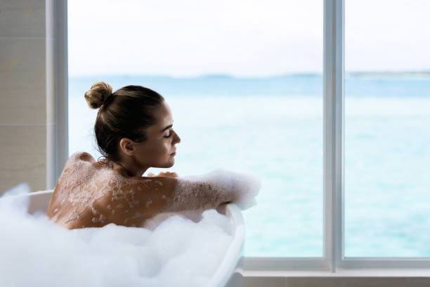 istock Rear view of sensual woman taking a bath. 1221313640