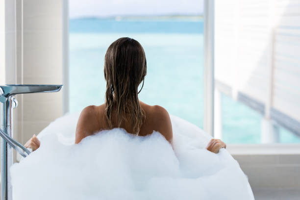 istock Rear view of a woman taking a bath. 1221313735