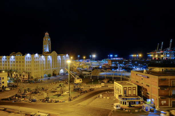 entrance of the port of montevideo harbor with cityscape skyline at night - harbor editorial industrial ship container ship imagens e fotografias de stock