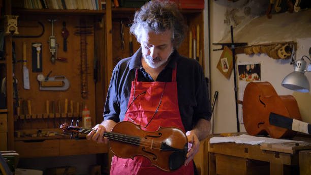 istock A professional violin master shows the violin made with his own hands 1221319145