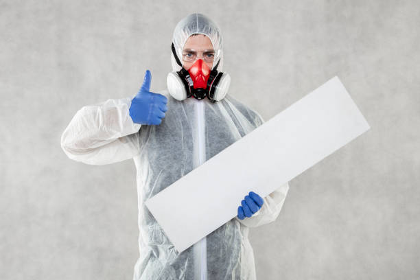 istock virologist in protective clothing holds advertising space in his hands 1221323664
