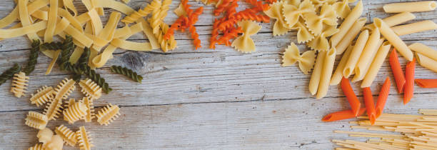 istock mix of different noodles on wooden background 1221323821
