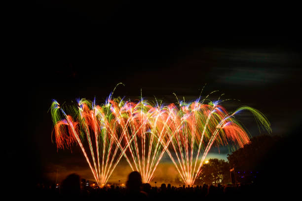 istock Night fireworks display, large numbers of people gathered. 1221327684