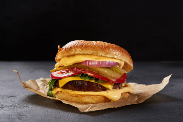 istock Freash and tasty burger over dark gray stone background 1221328840