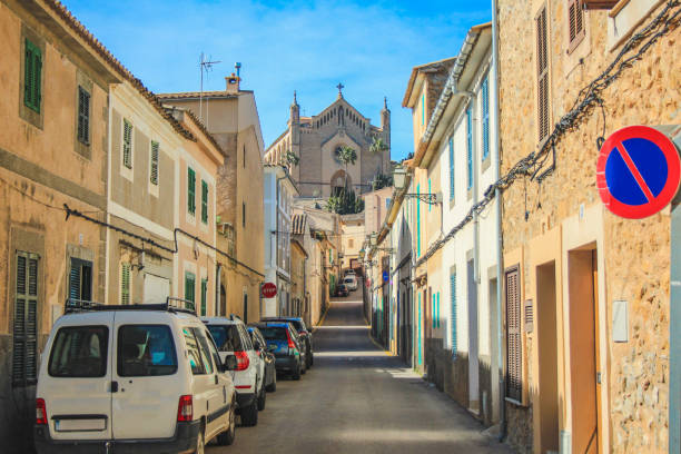Arta, Mallorca, Spain - March 23 2018: Empty street in Arta with Transfiguracio del Senyor church in the background