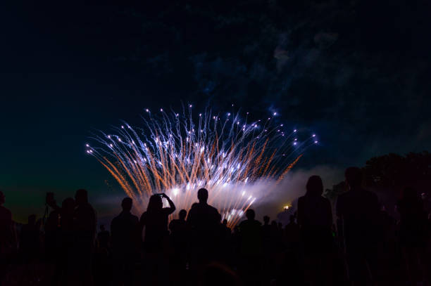 istock Night fireworks display, large numbers of people gathered. 1221333495