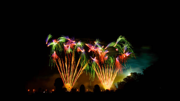 istock Night fireworks display, large numbers of people gathered. 1221333513
