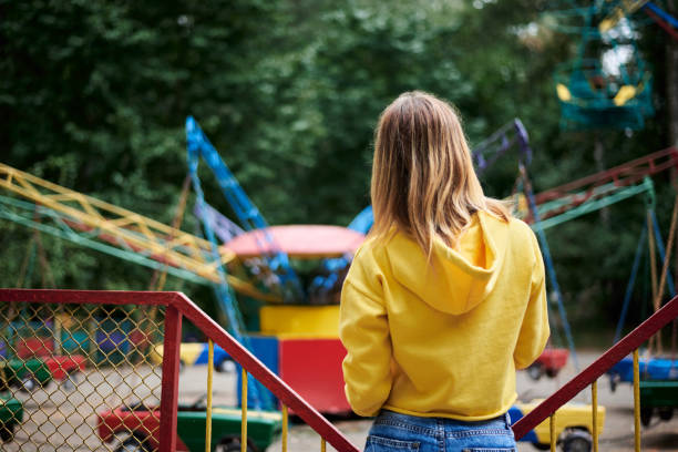istock Young blond woman in amusement park 1221334695