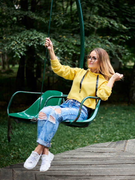 istock Young blond woman in amusement park 1221336288