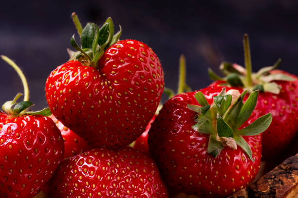 istock organic strawberries in wooden bowl 1221336849