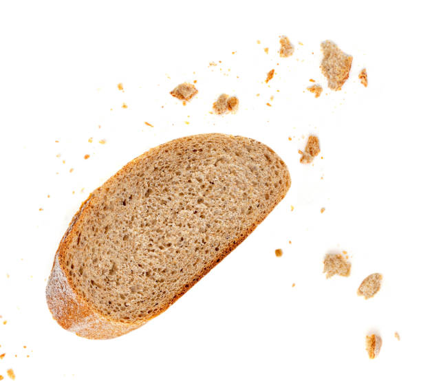 istock Bread slices and crumbs isolated on white background. Top view