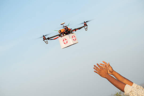 Drone Delivering First Aid Box or medicine to costumer hand during covid-19 or coronavirus lockdown - Advancing Medical Industry Logistics for Drug Transport concept. Drone Delivering First Aid Box or medicine to costumer hand during covid-19 or coronavirus lockdown - Advancing Medical Industry Logistics for Drug Transport concept drone stock pictures, royalty-free photos & images