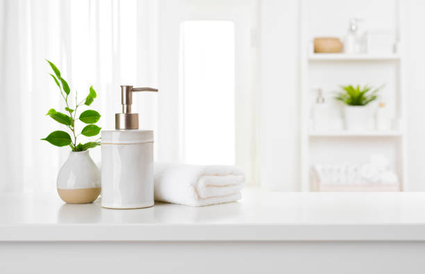 istock Soap dispenser and spa towel on pastel bathroom window interior 1221338033