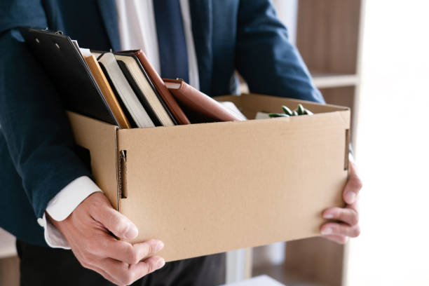 istock Midsection Of Businessman Holding Cardboard Box 1221338941