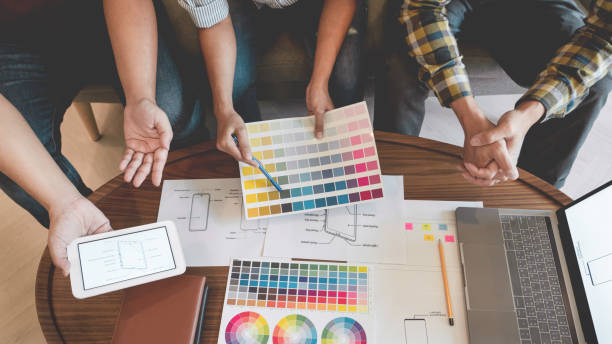istock Midsection Of Colleagues Choosing Color Swatch 1221339938