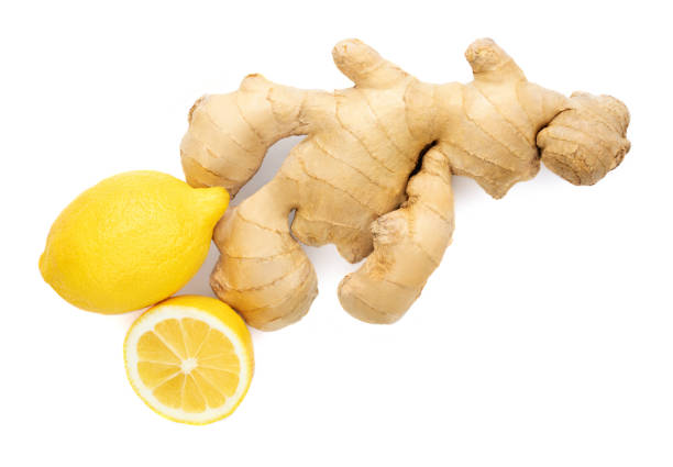 istock Fresh ginger root  with sliced and lemon fruit  isolated on white background. Top view. Flat lay. 1221340219