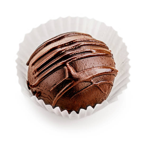istock Chocolate round candy  covered with chocolate stripes isolated on white background, macro 1221342316