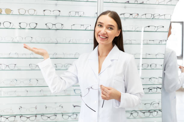 istock Happy optometrist helping client to choose glasses 1221344356