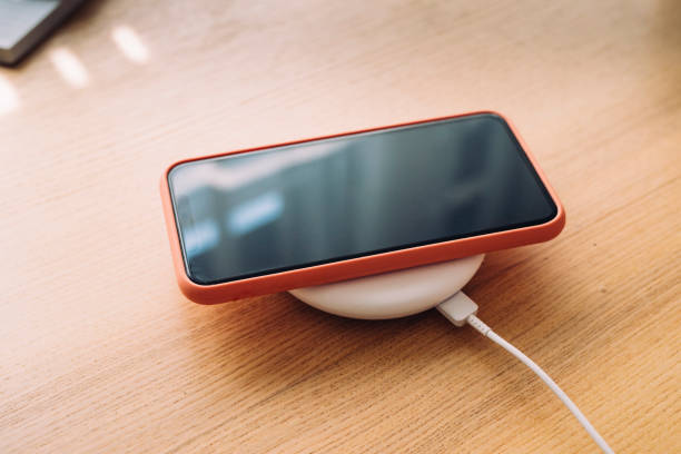istock Smartphone Charging on a Wireless Charger, a Close Up 1221344618