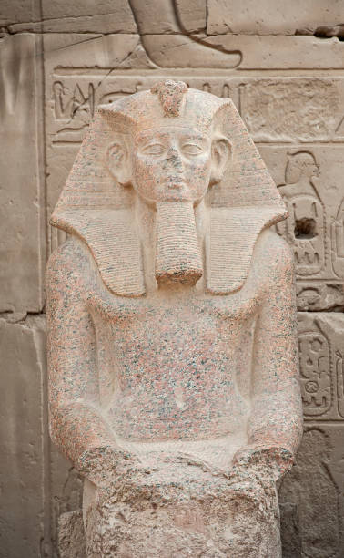 istock Statue and hieroglyphic carvings at an ancient egyptian temple 1221345286