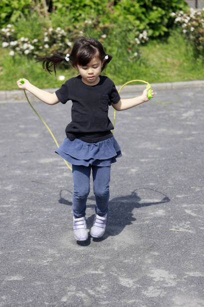 istock Japanese girl (5 years old) playing with jump rope 1221345357