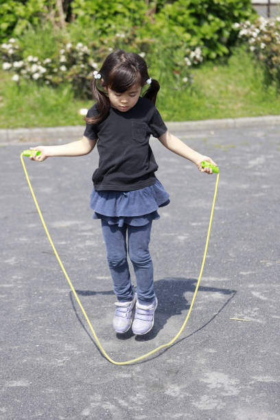 istock Japanese girl (5 years old) playing with jump rope 1221345382