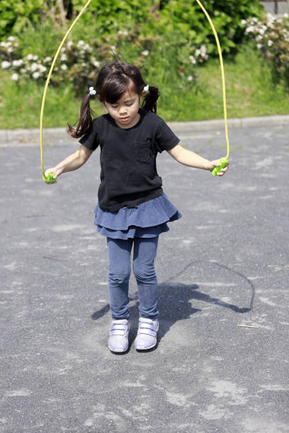 istock Japanese girl (5 years old) playing with jump rope 1221345438