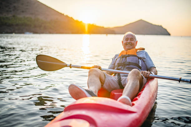 istock Smiling Senior Kayaker Resting at End of Morning Paddle 1221345540