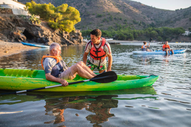 istock Male Kayakers Preparing to Push Off for Morning Paddle 1221345546