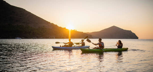 istock Tandem Kayakers Paddling in Mediterranean at Sunrise 1221345552