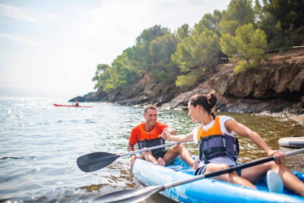 istock Kayakers Clasping Hands at the End of Mediterranean Workout 1221345603