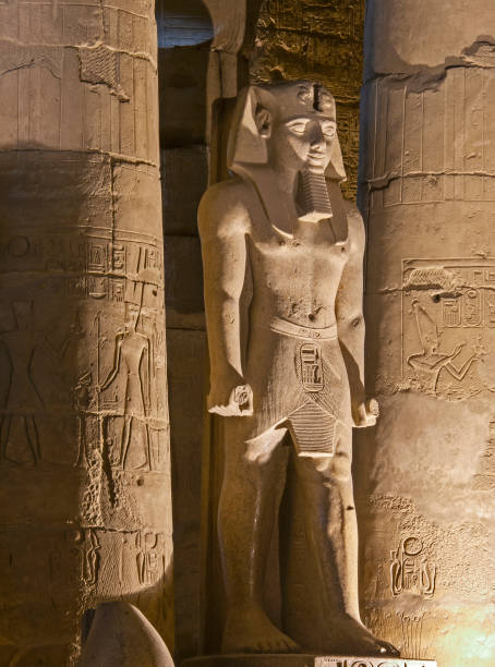 istock Ancient egyptian statue and carvings on wall in temple 1221345604