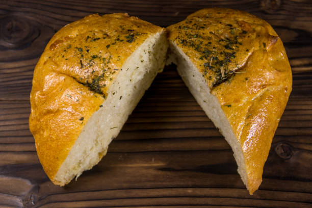 istock Fresh bread ciabatta on wooden table 1221346089