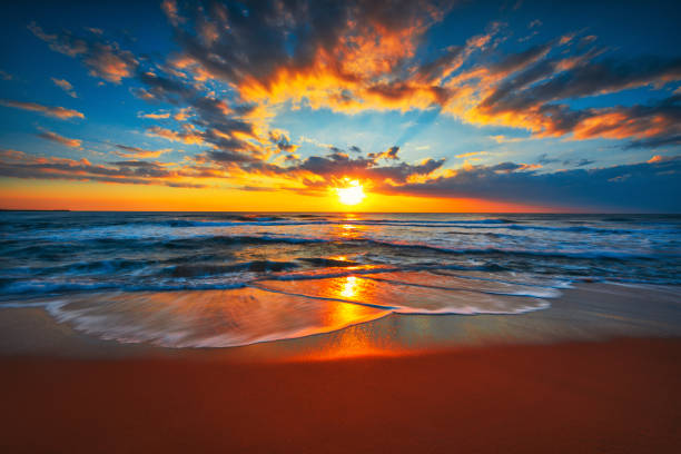 istock Sunrise on the beach and ocean waves on a tropical sea 1221347391