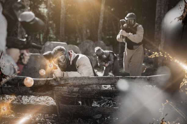 istock Paintball team aiming outdoors 1221347450